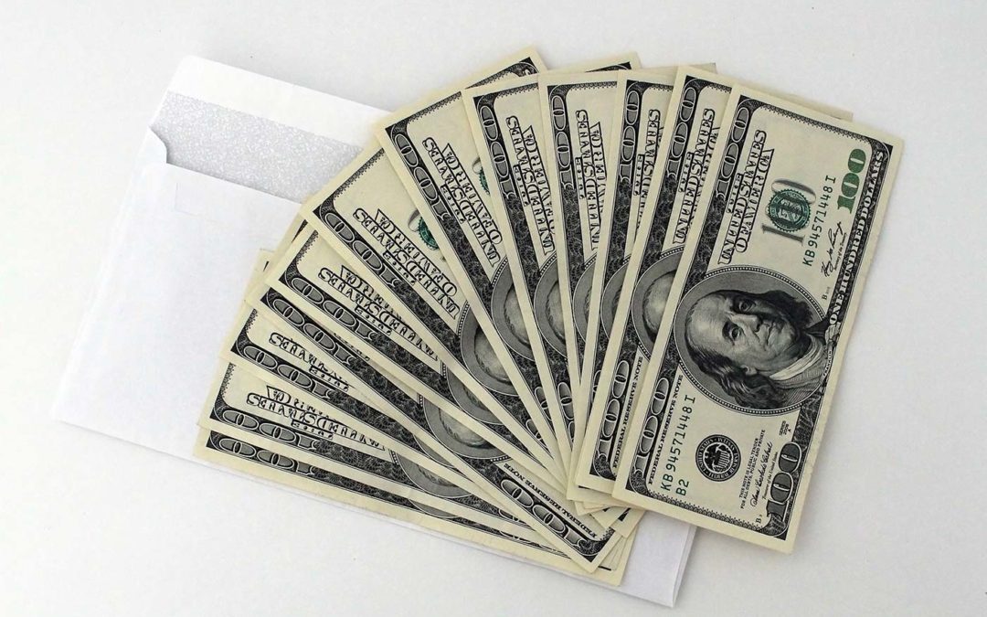 100-dollar bills spread out on envleope.